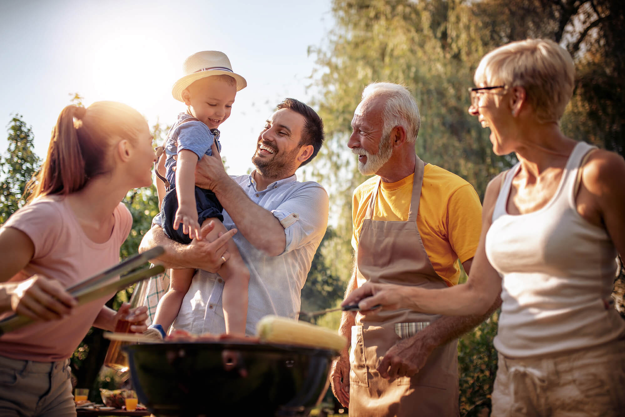 Happy family having barbecue in their garden